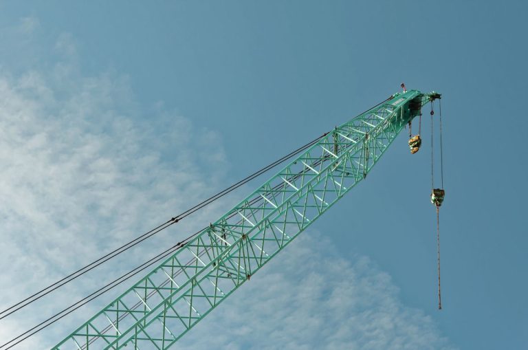 crane on a construction site reaching towards the sky